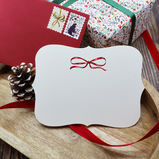 Cartolina Fiocco Rosso di Piperita Paper: sagomata con busta rossa, stampa a colori, perfetta per scrivere i vostri auguri di Natale